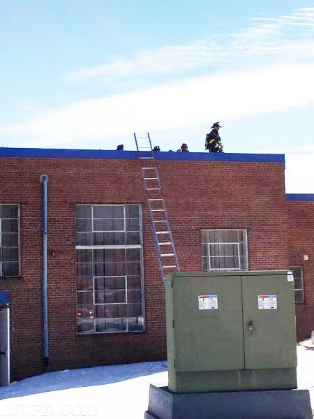 Firefighters operating on the roof of Mechanicsville Elementary School where an electrical fire occurred in a HVAC unit. located above the gymnasium 